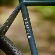 Load image into Gallery viewer, Bicycle frame with 'Temple' branding on a blurred natural background
